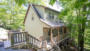 A small cabin with a porch, wooden deck, and a stone pathway leading to the entrance. - Walk to Beech Mtn Resort, Sleeps 12, Game Room (Beech Mountain)