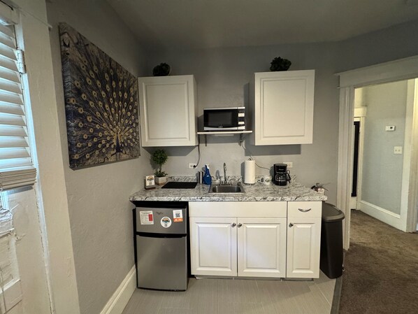 Fridge, microwave, coffee/tea maker, cookware/dishes/utensils