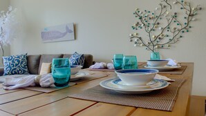 A dining table set with blue glassware and white plates, a decorative tree wall art, and a 'Welcome' sign on the wall. - 5 min walk to BEACH (1 block). Newly RENOVATED Spacious 3Beds 3Baths (Gulfport)