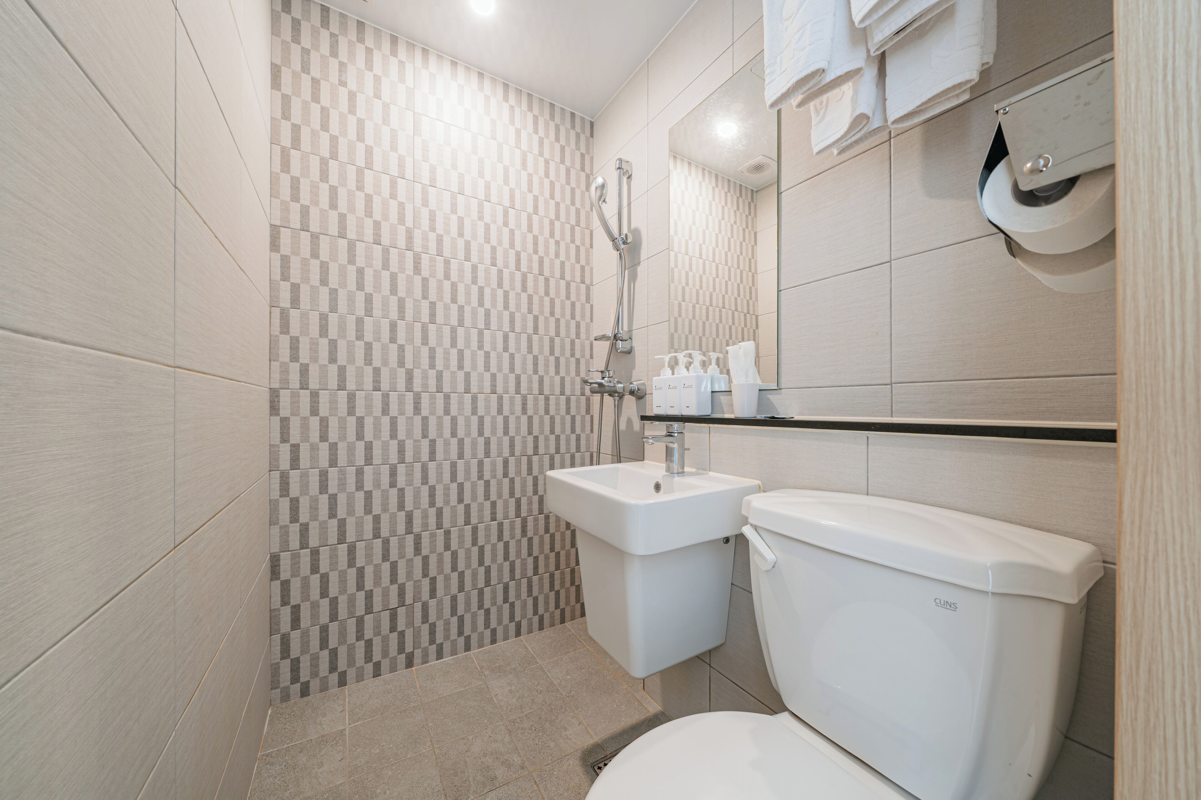 shower, hair dryer, slippers, towels