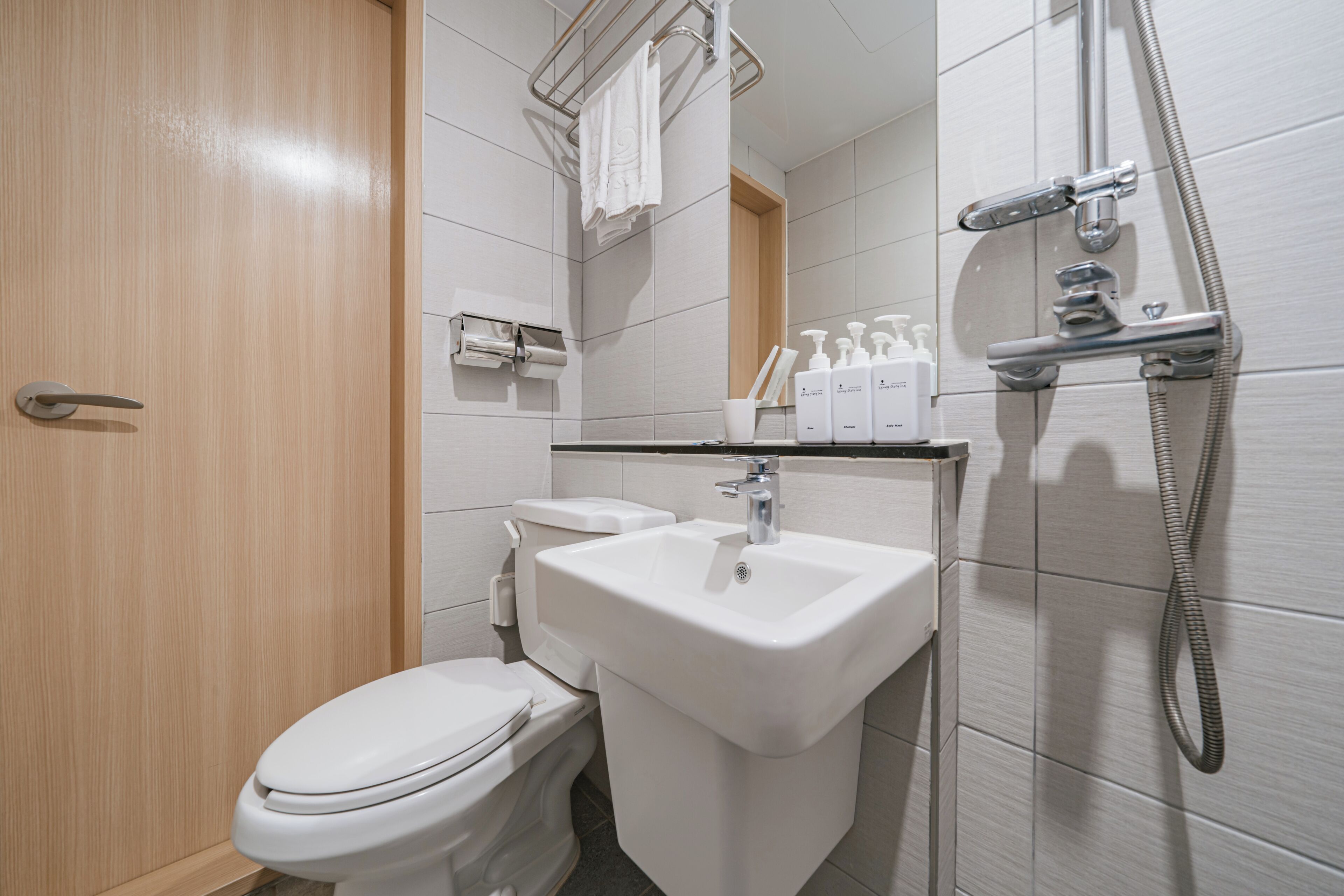 standard single room, city view | bathroom | shower, hair dryer, slippers, towels