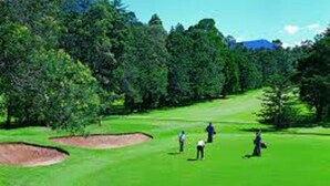 A golf course with sand bunkers, trees, and a clear sky. - Sana Guest (Weligama)