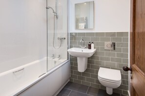 Combined shower/bathtub, hair dryer, towels, soap