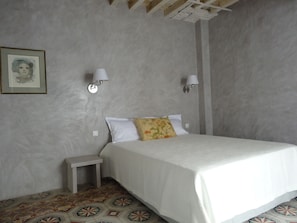 A bedroom with a bed, nightstand, and two wall-mounted lamps. - "Old Center" Charming House with Terraces and Garage  (Arles)