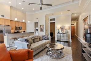 Designer Queen Sofa in the Living Room with high ceilings and fan