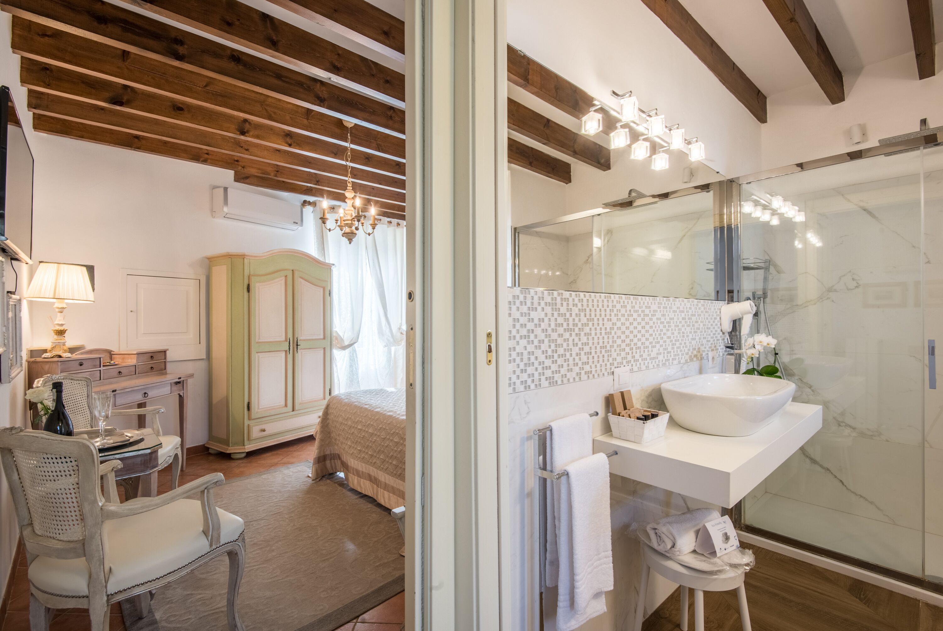 Un baño moderno con un espejo grande, un lavabo blanco y una cabina de ducha de vidrio.
