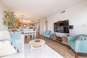 Relax in a comfortable seating area with a sofa, armchairs, and TV.