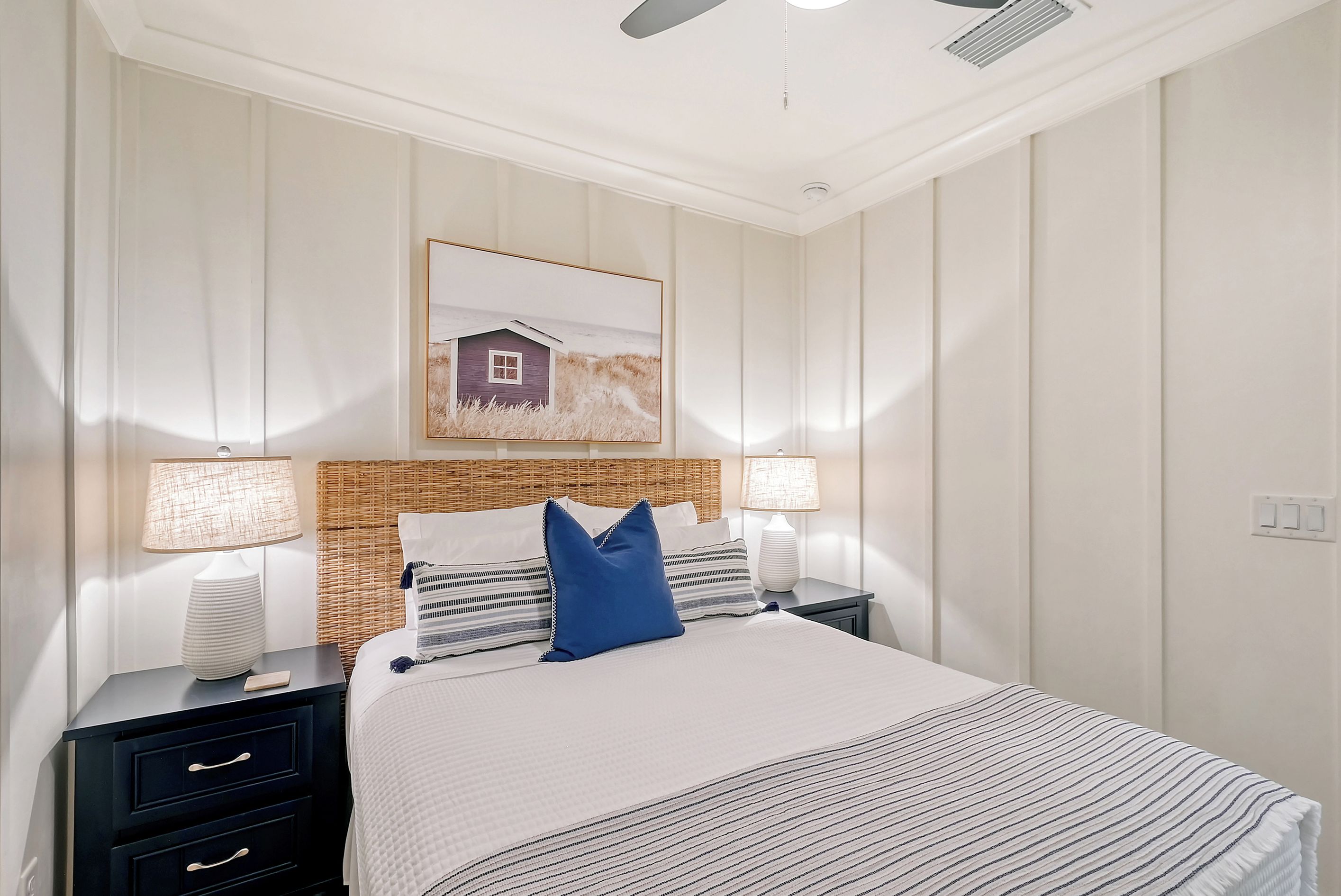 There are four drawers for clothing and hanging closet space in this queen bedroom.