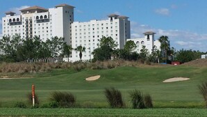 A golf course with bunkers and a large hotel in the background. - 2 Bed/2 Bath Resort Condo near Disney. (Davenport)