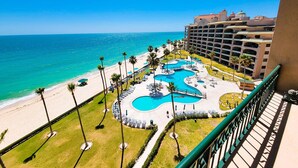 A resort with a pool area, beach, and ocean view.