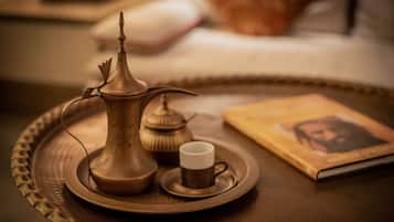 A tray with a teapot, a cup, and a book on a table.