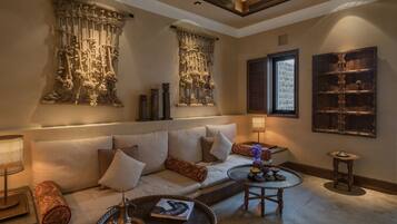 A cozy living room with a sofa, a coffee table, and decorative items.