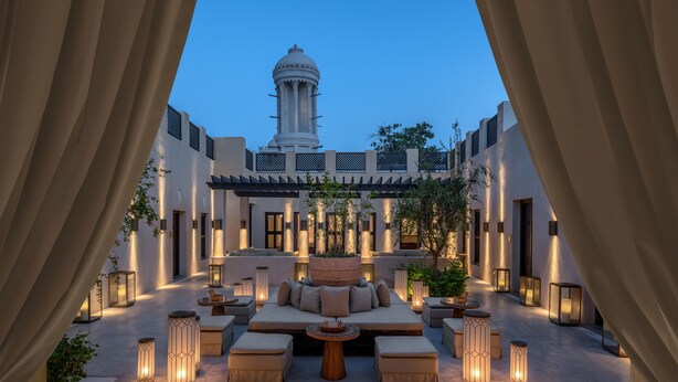 A courtyard with a seating area, lanterns, and a view of a building with a dome. - The Chedi Al Bait, Sharjah, UAE (Sharjah)