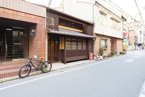 A traditional Japanese building with a wooden exterior and a bicycle parked in front.