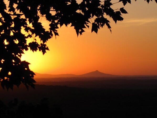 A mountain silhouette against a sunset.