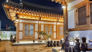 A traditional Korean building with wooden architecture, a tiled roof, and a stone pathway leading to the entrance. - Nadul Hanok (Gyeongju)