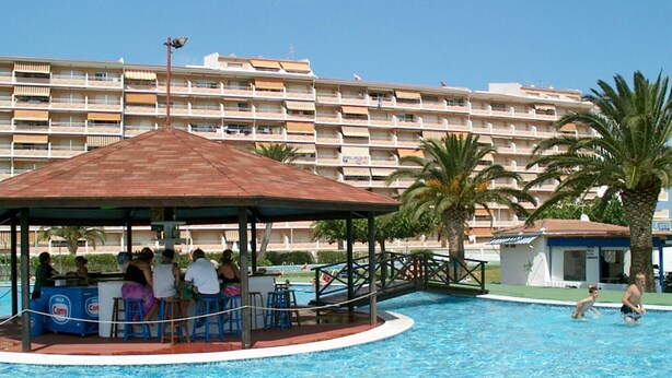 A swimming pool area with a covered seating area and a poolside bar. - Peñismar I D 2-10 (Peñiscola)