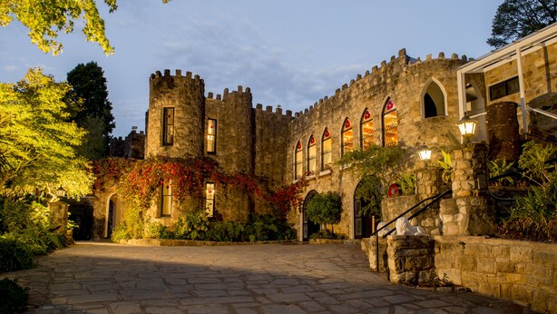 A historic stone building with arched windows and a central tower. - The Manor Basket Range (Basket Range)