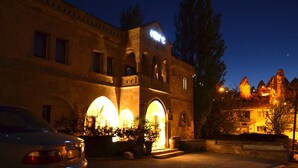 A historic building with arched entrances and a sign that reads "Hotel." - Kufe Hotel (Nevsehir)