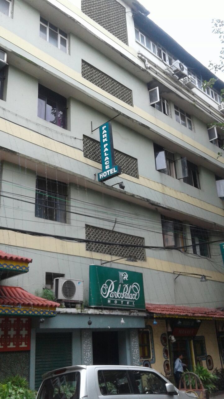 A multi-story building with a sign indicating it is a hotel.