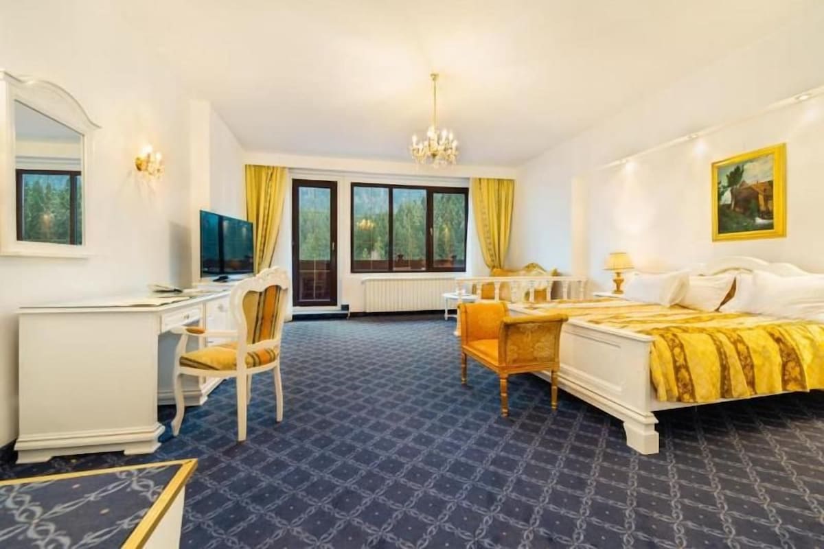 Une chambre d’hôtel équipée d’un lit, d’un bureau, d’une chaise et d’un téléviseur.
