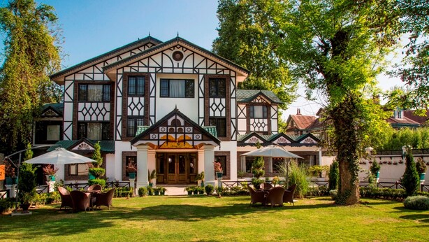 A traditional building with a symmetrical facade, large windows, and a central entrance. - Lemon Tree Hotel Srinagar (Srinagar)