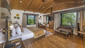 A spacious bedroom with a large bed, a wooden ceiling, and a television. - Lemon Tree Hotel Srinagar (Srinagar)