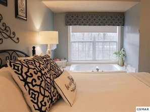 Jacuzzi brand whirlpool tub in main bedroom with pleasant views. 