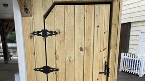 A wooden door with a metal latch and a small step leading up to it. - LAKEFRONT, 5 BDRM, Ocean View! Quiet. Fish off deck. Just reduced Aug wks! (Myrtle Beach)