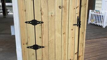 A wooden door with a metal latch and a small step leading up to it.