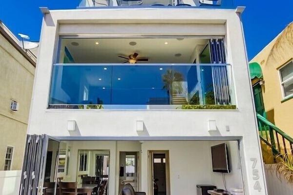 Front of House with Sliding Doors Open