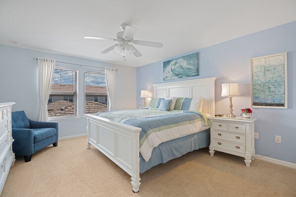 A bedroom with a bed, a nightstand, a chair, and a ceiling fan. - Windsor @ Westside
5 Bed, Private townhouse, Private Pool, Wonderful Amenities (Kissimmee)