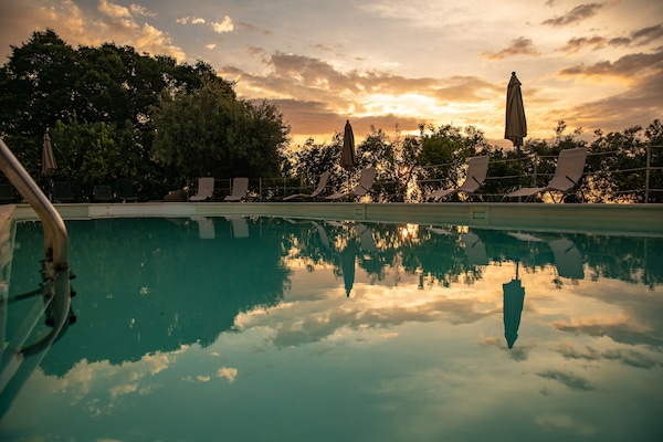 Outdoor pool, open 9:30 AM to 7 PM, pool umbrellas, sun loungers