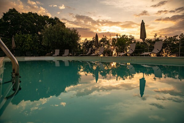 Outdoor pool, open 9:30 AM to 7 PM, pool umbrellas, sun loungers