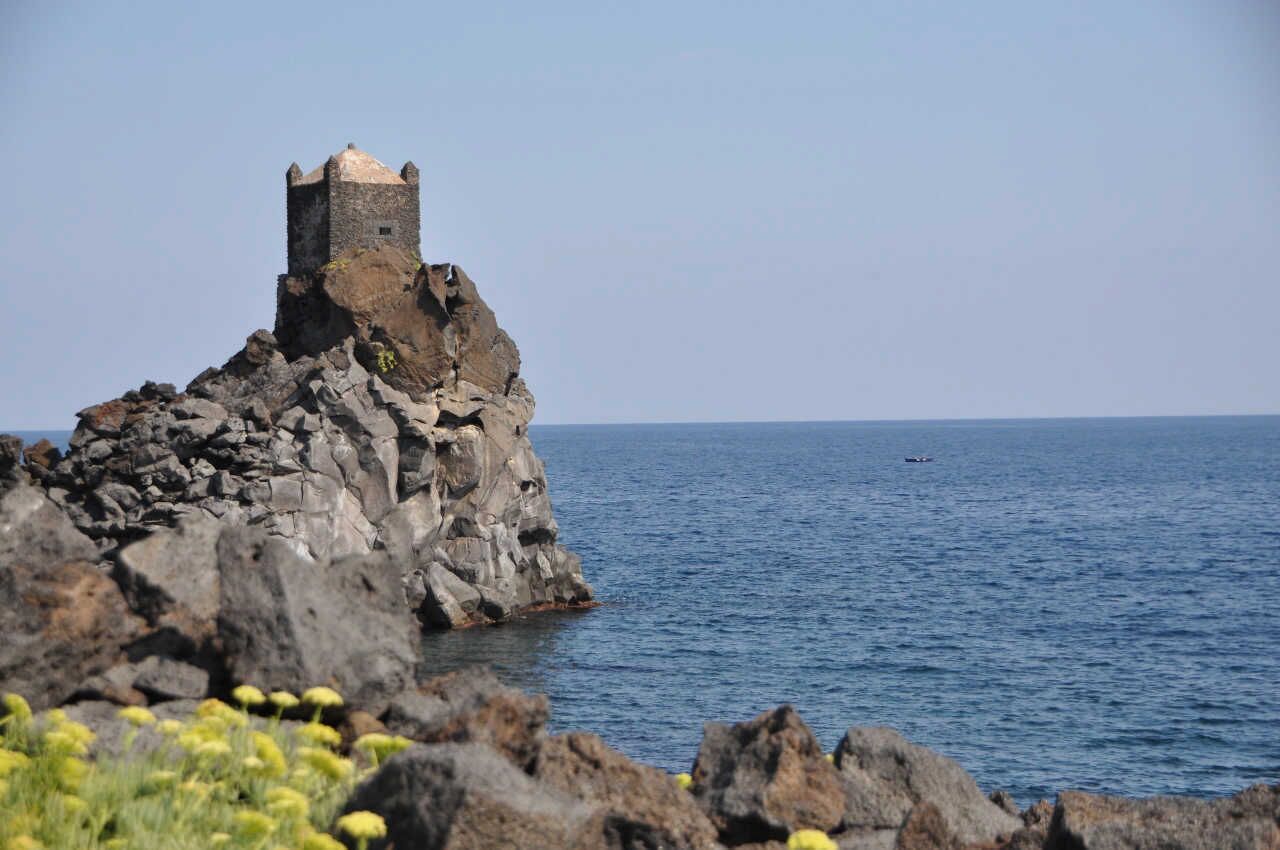 A coastal rock formation with a medieval tower.