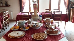 Une table à manger dressée avec différents plats et agrémentée d’un centre de table.