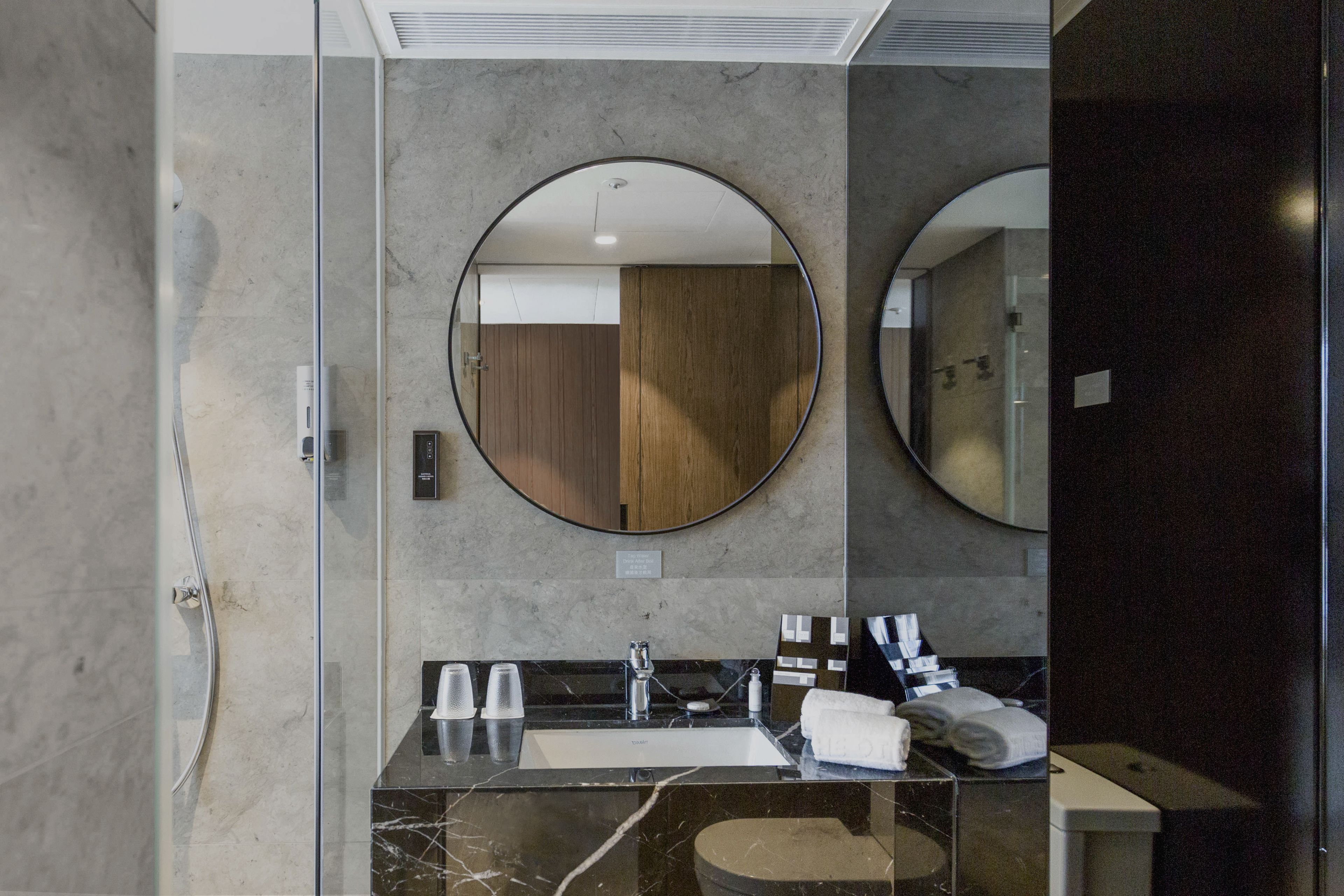 shower, hair dryer, slippers, towels