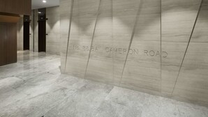 A modern interior with a marble floor and a wall with a geometric pattern. - The Otto Hotel (Kowloon)