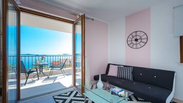 Premium Condo, 1 Bedroom, Balcony, Sea View | Living area | 25-inch flat-screen TV with satellite channels, TV