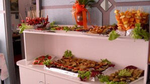 A buffet with various food items including skewers, salads, and appetizers. - Hotel Acquazzurra (Rimini)