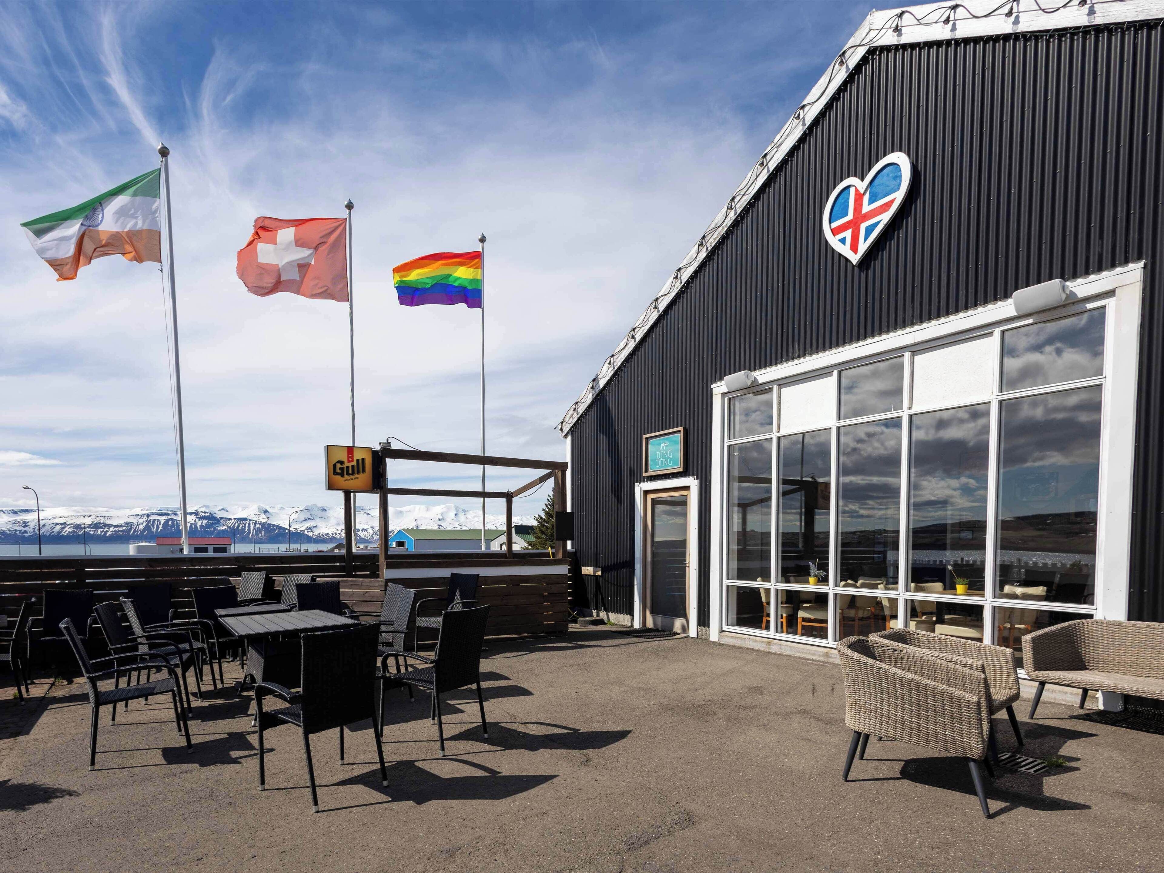 A building with a black exterior, a large glass door, and a sign reading "The Gulls".