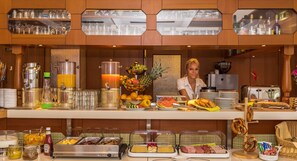 Una mesa de buffet con diversos alimentos, bebidas y aderezos.