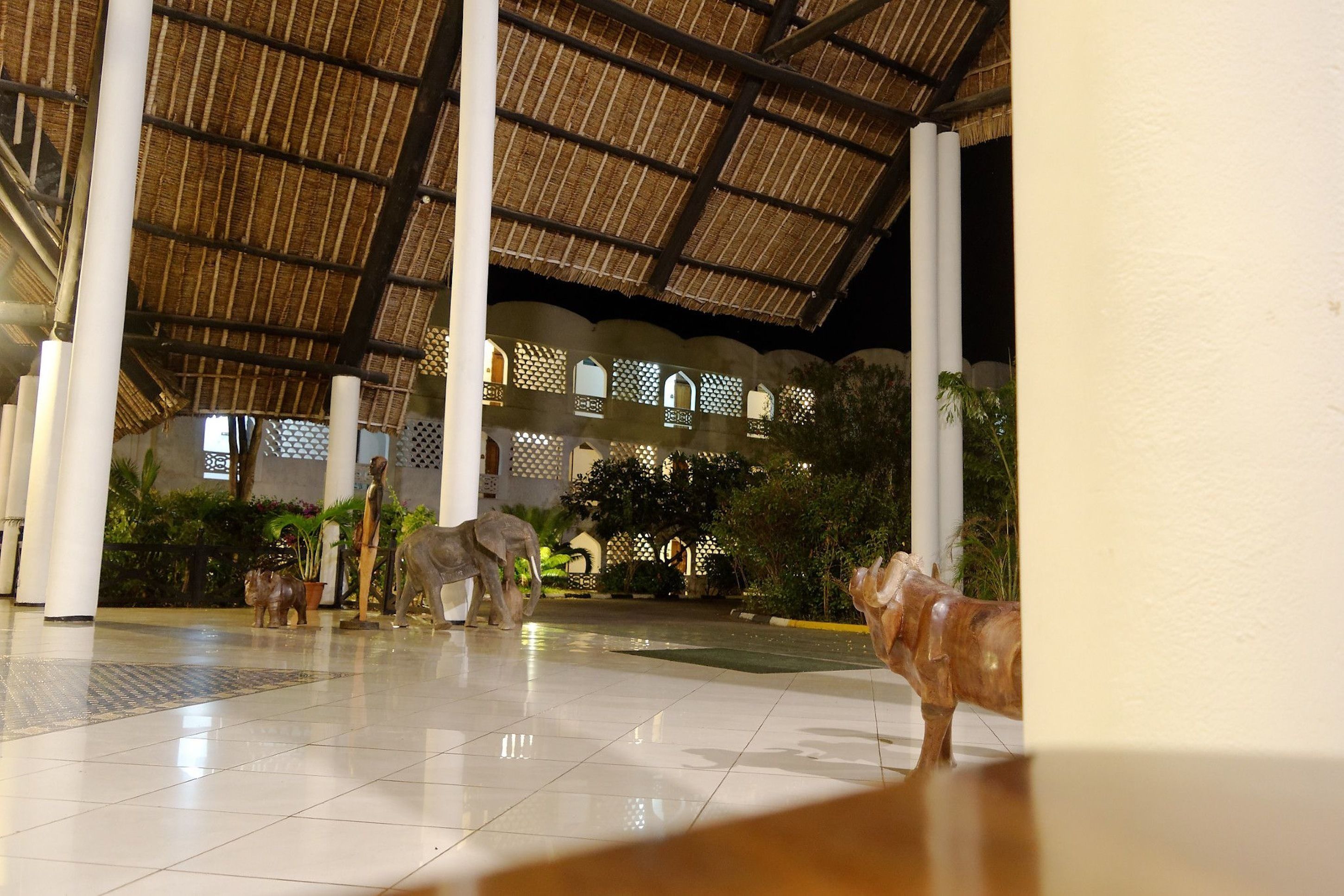 A spacious lobby with a high ceiling, large columns, and decorative animal sculptures.
