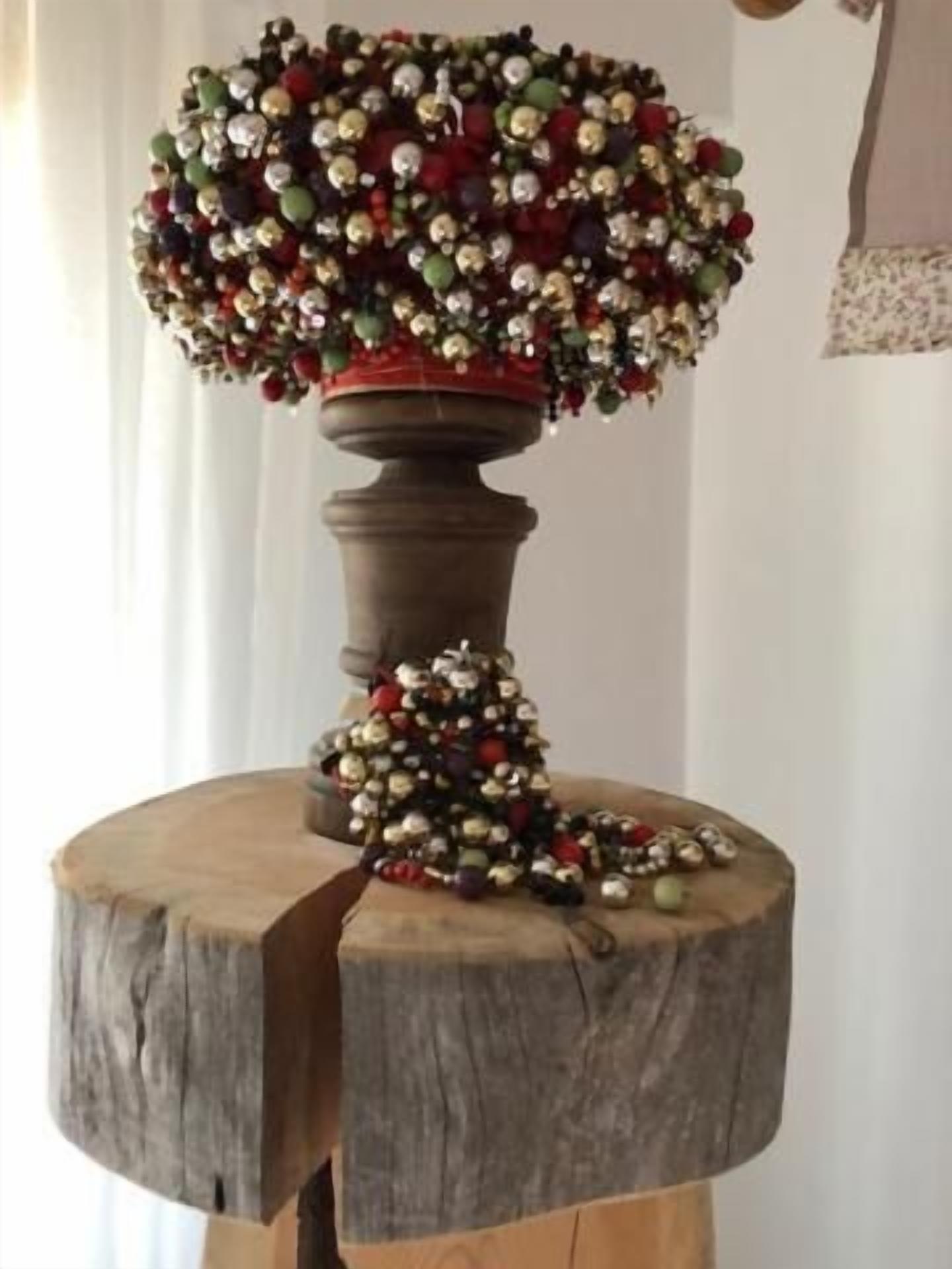 A wooden table with a decorative arrangement on top, including a bowl and scattered ornaments.