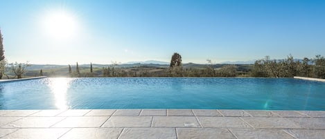 Seasonal outdoor pool, an infinity pool, pool loungers