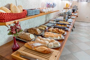 A buffet with various baked goods and pastries.