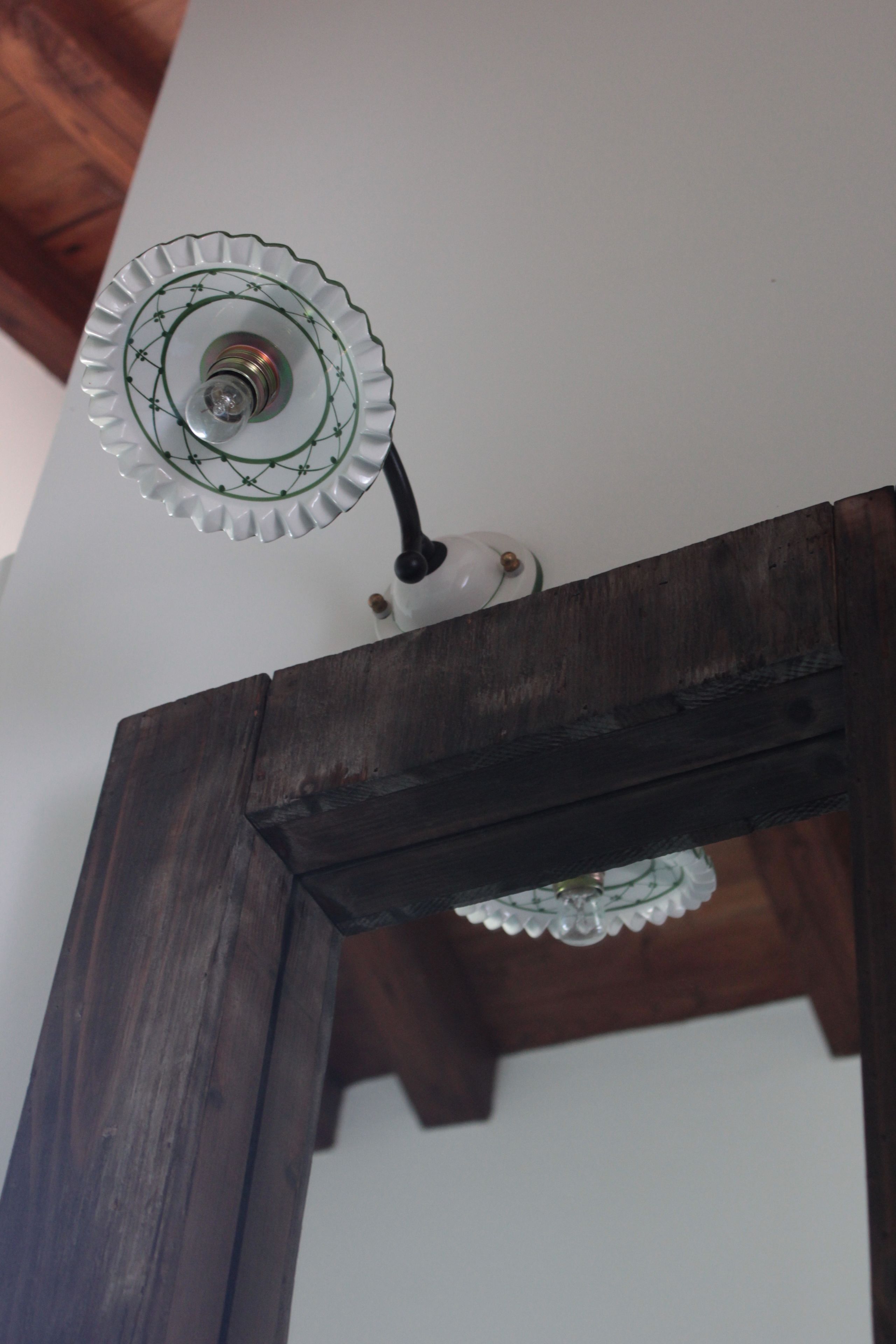 A ceiling light fixture with a decorative glass shade and a white base.