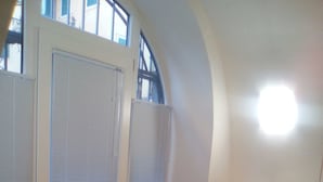 A room with a sofa, a radiator, a door with blinds, and a window with a view. - Casa Portici (Torri del Benaco)