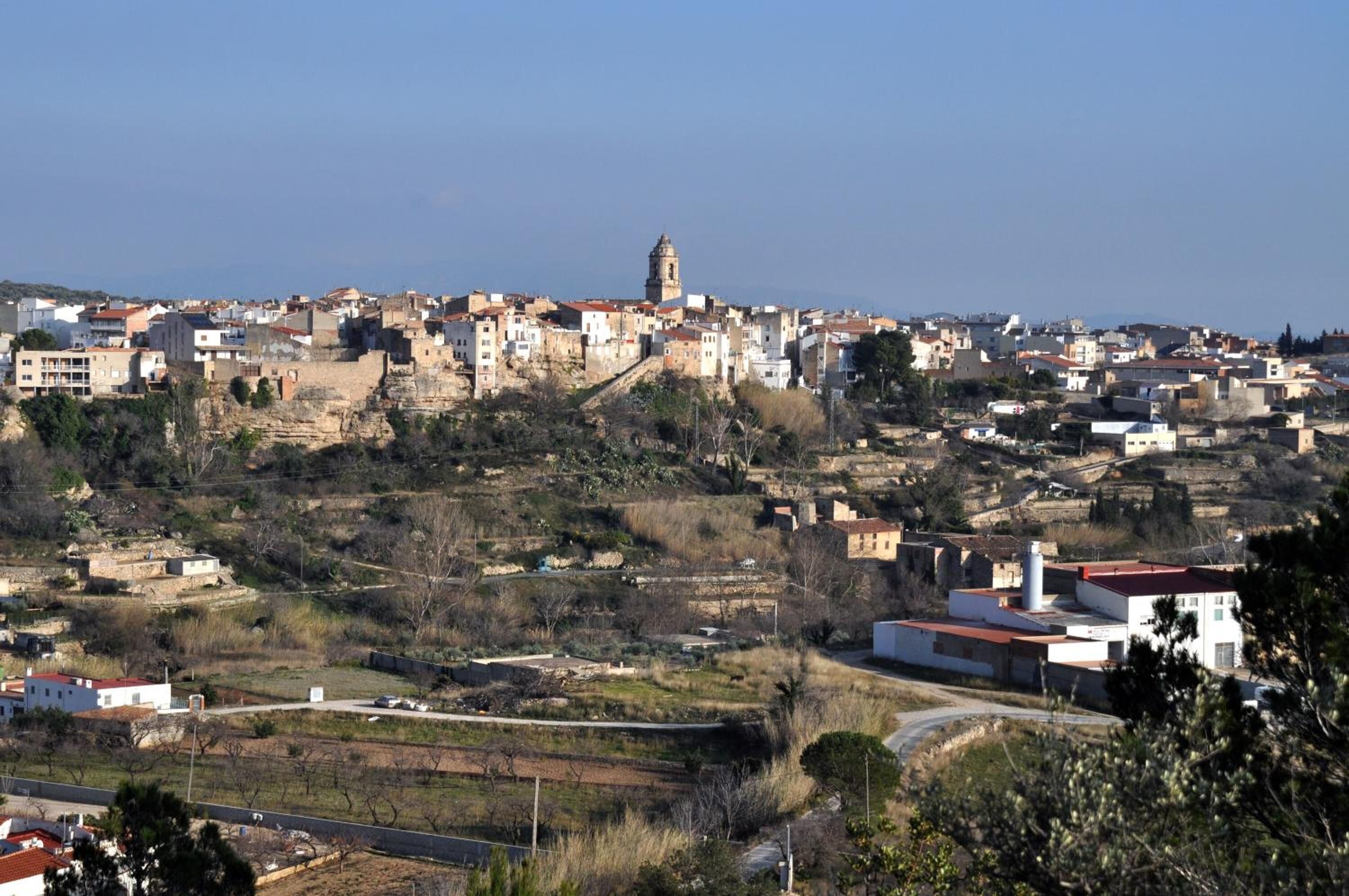 A town with historic buildings, a prominent tower, and a mix of residential and commercial structures.