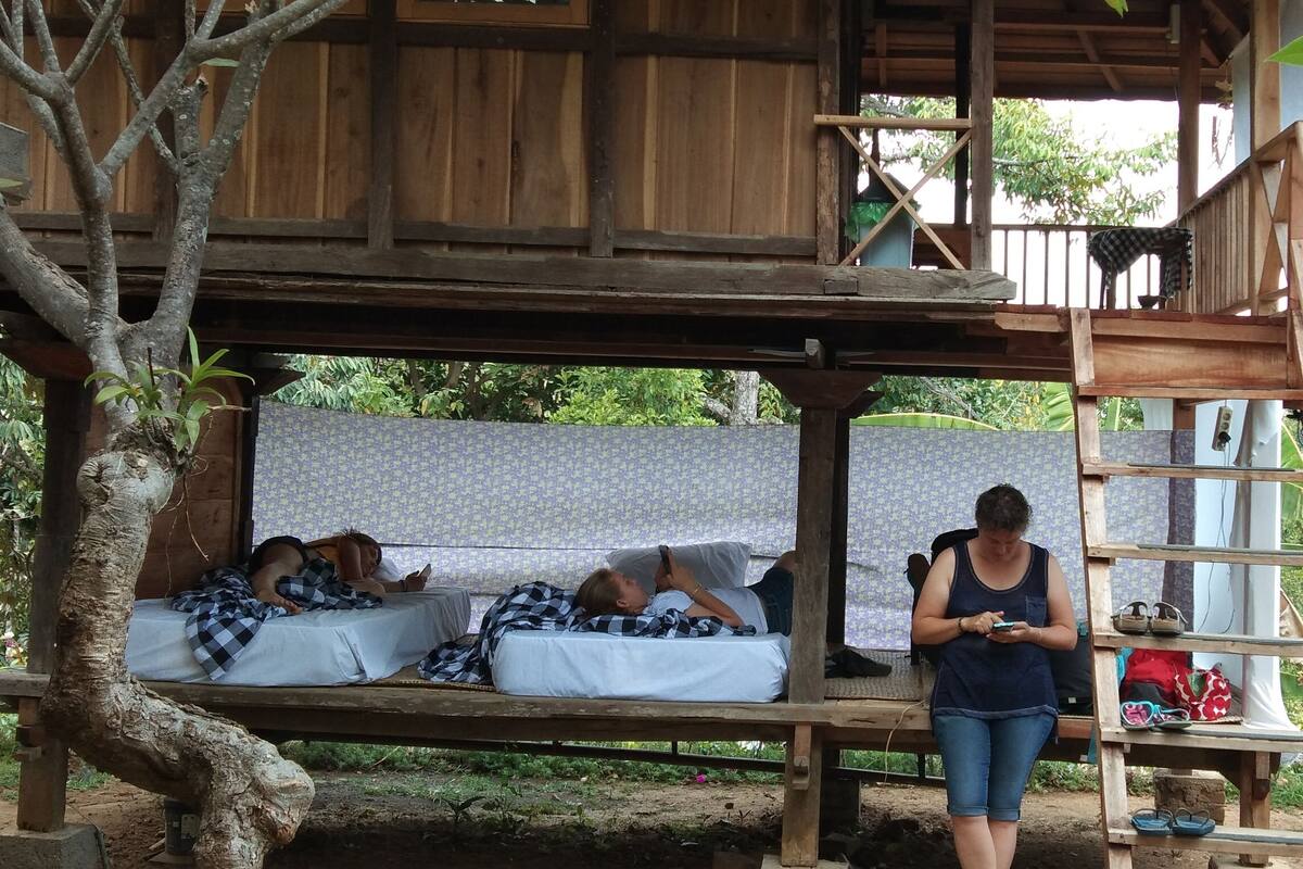 A wooden structure with a bed and a ladder.